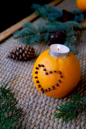 Craft from an orange. Handwork. Christmas decor with orange. Christmas table setting with holiday decorations. New year food holiday, holiday, food art conceptの写真素材