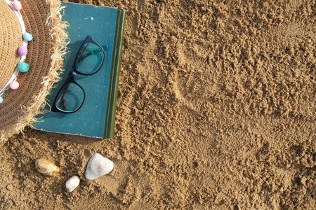 beach accessories on the sand. Sunglasses, hat flip-flops and striped hat. summer is coming concept. High quality photoの写真素材