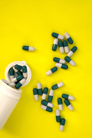 Epidemic disease. On the table are pills and a thermometer on a yellow background. Elevated...