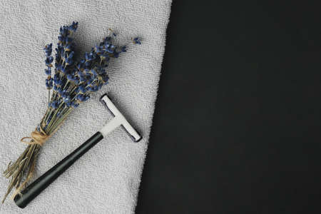 Banner depilation and beauty concept. On a dark and white background with lavender flowers.