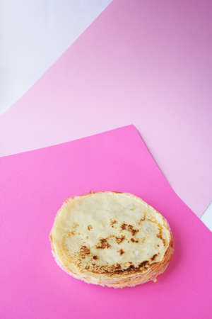 Russian pancakes with fresh cream cheese. Colored pink background. High quality photoの写真素材