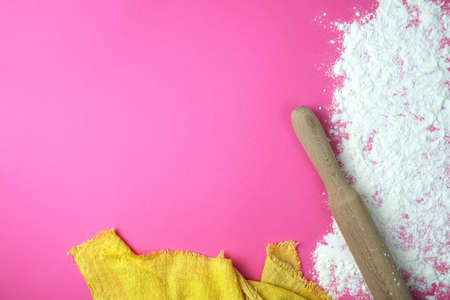 Baking background with copy space on a pink surface for your text. View from above. Flour is a traditional ingredient in bread and other baked goods. Often used in Italian, Russian, Arabic and Chinese cuisines.の写真素材