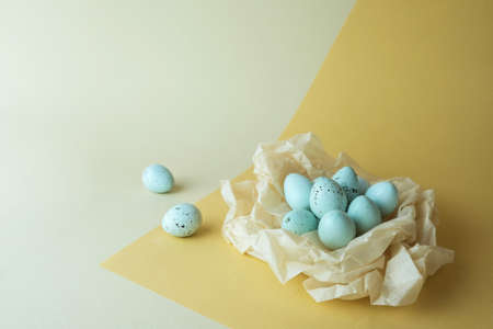 Commercial studio filming of blue quail eggs in a paper nest. Advertising photo.の写真素材