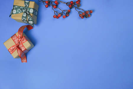 Happy New Year and Merry Christmas 2022. Christmas background with New Years toys and red twigs on a...
