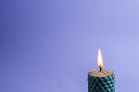 Candle on a blue background. Place for text. The concept of aromatherapy.の写真素材