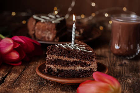 Plate with pieces of delicious homemade chocolate cake on the tableの写真素材