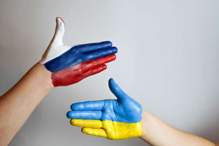 Hand painted in the colors of the flag of Russia and Ukraine. War in Ukraine.の写真素材