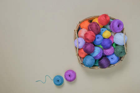 Woolen or cotton balls of thread in a basket, balls of bright colors in a basket for crocheting or...