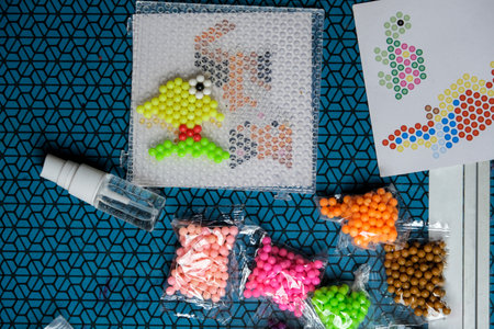 Step 3. The child plays with the mosaic at home. Childrens creative game for early development and fine motor skills. Aquamosaicの写真素材
