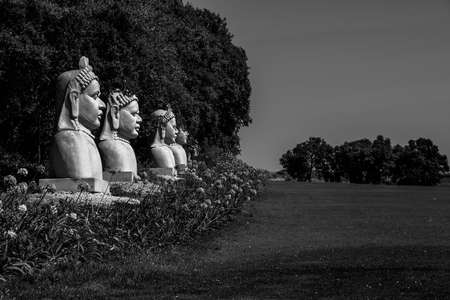 faces of oriental statue in a gardenの写真素材