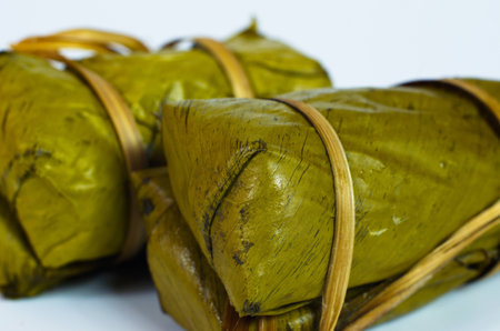 Porridge tie. Sticky rice wrapped in banana leaves, banana filling, steamed cooked food.の写真素材