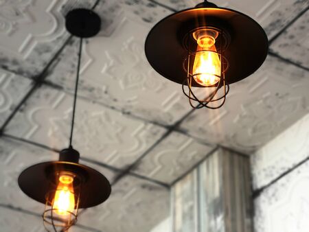 Black lamp hanging light, warm light, ancient shape.の写真素材