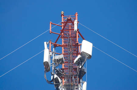Internet towers and transmission equipment on clean blue sky background