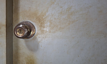 Stubborn dirt and grime on doorknobs and door panelsの写真素材