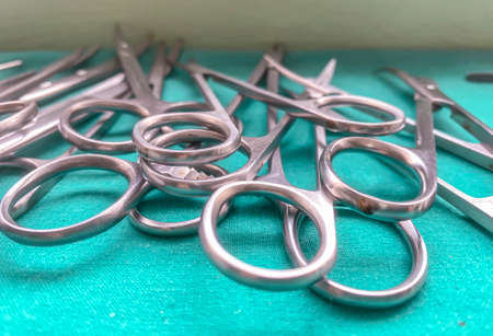 Surgical scissors on  table,blue background.の写真素材
