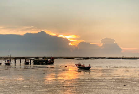BANGSAEN, THAILAND 2022: Panorama of the evening atmosphere.Fishing boat stuck on the rocks on Ang Sila Market, the center of Chonburi's seafood for touristsのeditorial素材