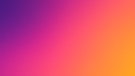 A smooth gradient blending pink, purple, orange, and yellow hues, creating a vibrant and warm abstract background.の写真素材