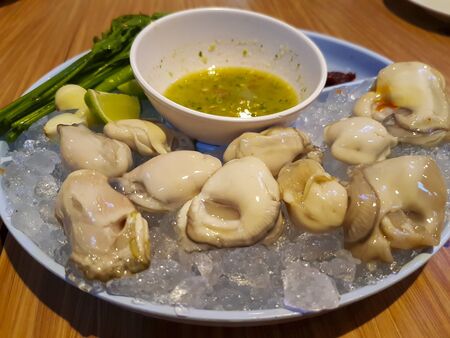Fresh oysters and spicy dipping sauceの写真素材