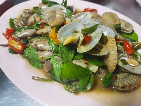 Stir fried clams with basilの写真素材