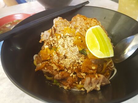 Spicy flat noodles with porkの写真素材