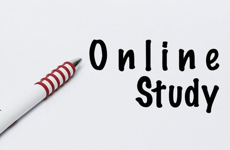 pen writes online study on white blank paperの写真素材