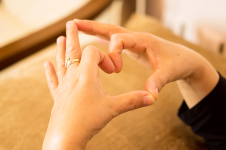 The expression of love making heart sign with fingers The expression of love making heart sign with fingers