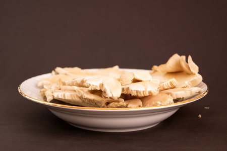 A type of mushroom made in a white plate with a grill.の写真素材