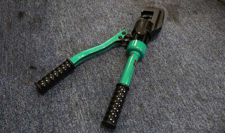 A pair of green clippers on a gray background.