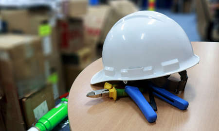 Close-up of a white hard hat on a table in a warehouseの写真素材