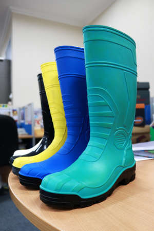 Rubber boots in the store. Green and blue rubber boots.の写真素材