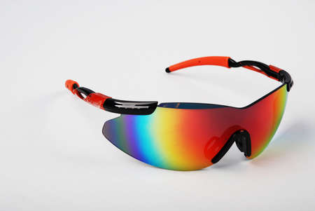 Sunglasses with multicolored lenses in an iron frame on a white backgroundの写真素材