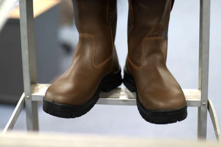 Women's brown boots on a shelf in a store, close-upの写真素材