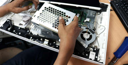 Close-up Of A Computer Repairman Repairing Mainboard Computerの写真素材