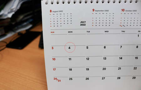 Close up of white calendar on office desk. Business and planning concept.