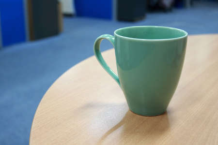 Coffee cup on the wooden table. Selective focus.