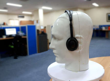 Headphones and a mannequin in the office. Selective focus.の写真素材