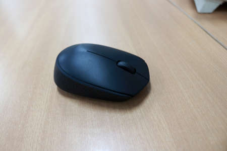 Wireless computer mouse on the laminate floor.の写真素材