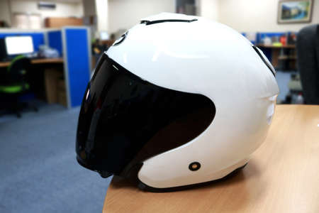 Helmet for motorcyclists, this sport helmet is white. This helmet serves to avoid collisions on the headの写真素材