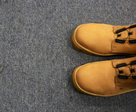 A pair of brown men's shoes on a gray background. Top view.の写真素材