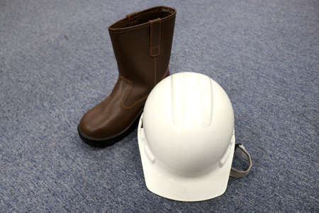 Helmet and boots on a gray background. Construction and building concept.の写真素材