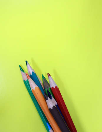 Colored pencils on a green background. Place for text.の写真素材
