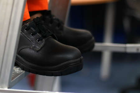Men's black leather shoes in the store. Close-up.