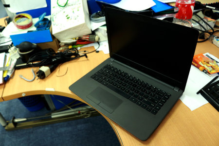 Photo of a black laptop on an office deskの写真素材