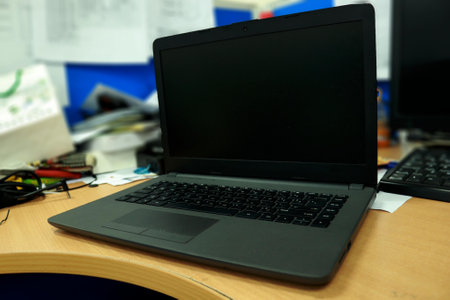 Photo of a black laptop on an office deskの写真素材