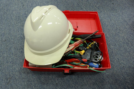White safety helmet in red plastic box on the floorの写真素材