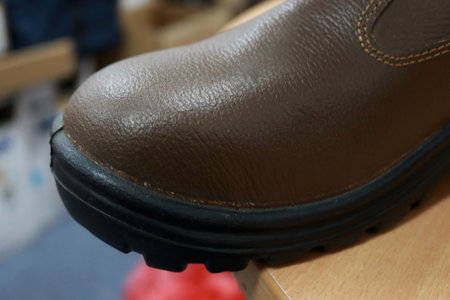 Brown boots for workers to protect their feet when working, these shoes are mandatory safety equipment for construction workersの写真素材