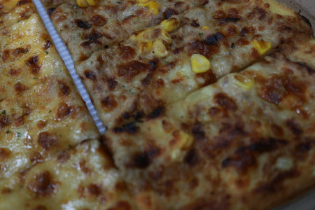 Close up of pizza with corn on top. Selective focus.の写真素材