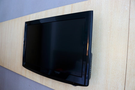 TV on the wooden wall in the living room of the house.の写真素材