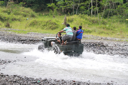 Unidentified people driving a 4x4 off-road vehicle.の写真素材