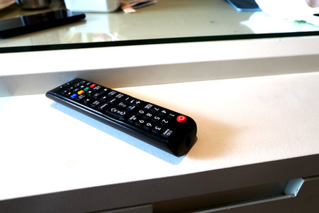TV remote control on a white table. Remote control on the table.